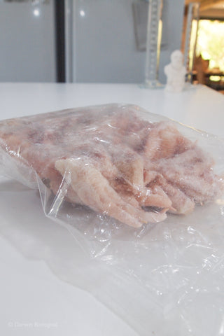 Plastic bag containing 1kg frozen chicken feet.