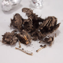 Load image into Gallery viewer, Dissected owl pellet showing bones and skull